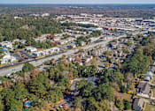 Thumbnail 20 of 25 - A bird's eye view of a suburban area with roads, houses, and trees.
