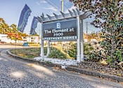 Thumbnail 25 of 25 - A sign for The Element at 3900 Apartment Homes is displayed in front of a building.