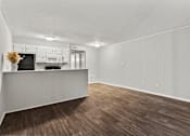 Thumbnail 13 of 25 - A kitchen with white cabinets and a wooden floor.