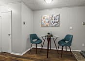 Thumbnail 9 of 25 - A dining room with a table and two chairs.