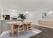 Thumbnail 5 of 25 - A dining room with a wooden table and chairs.