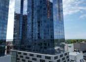 Thumbnail 31 of 31 - a tall blue building in the middle of a city