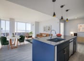 Thumbnail 2 of 31 - 3thirty3 new rochelle ny apartment high rise photo of kitchen and living room with large windows and modern furnishings