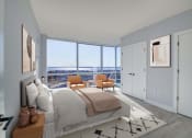 Thumbnail 4 of 31 - 3thirty3 new rochelle ny apartment high rise photo of bedroom with large windows and modern furnishings