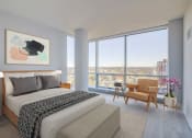 Thumbnail 3 of 31 - 3thirty3 new rochelle ny apartment high rise photo of bedroom with large windows and modern furnishings