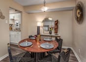 Thumbnail 25 of 34 - A dining room with a round table set for two.