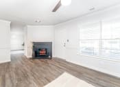 Thumbnail 4 of 20 - a living room with a fireplace and a window