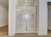 Thumbnail 11 of 20 - a walk in shower with a glass door in a bathroom