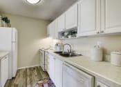 Thumbnail 6 of 15 - Derby Park Apartments in Daytona Beach, FL photo of a kitchen with white cabinets