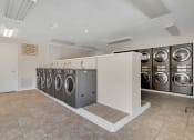 Thumbnail 22 of 28 - Addison Lane Apartment homes in Gainesville Florida photo of photo of washer and dryers in a laundry room