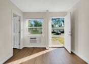 Thumbnail 14 of 28 - Addison Lane apartments in Gainesville, FL photo of a bedroom with two doors and an air conditioner in the window