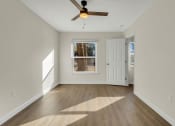 Thumbnail 15 of 28 - Addison Lane apartments in Gainesville, FL photo of a empty living room with a ceiling fan