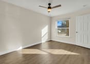 Thumbnail 16 of 28 - Addison Lane Apartment homes in Gainesville Florida photo of photo of a bedroom with hardwood floors and a ceiling fan