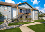 Thumbnail 16 of 20 - Beaumont, TX Apartments – Breakwater Bay - Outside of Breakwater Bay apartments with pathway for walking
