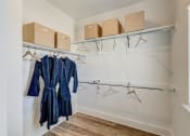 Thumbnail 21 of 56 - a walk in closet with white walls and a window