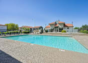 Thumbnail 2 of 46 - Newly Renovated Mesa, AZ, Apartments - Mesa Station Apartments - Swimming Pool With Clear Blue Water, Lounge Chairs, Fenced Sundeck, and Landscaping.