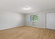 Thumbnail 14 of 23 - Element at 4411 Macon Apartments A room with a white door and a window with a view of trees.