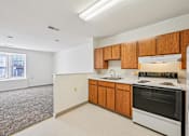 Thumbnail 2 of 32 - A kitchen with white appliances and wooden cabinets.