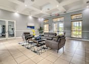 Thumbnail 17 of 28 - A spacious living room with a large grey sofa set and a coffee table in the center.