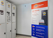 Thumbnail 23 of 31 - A Tide Cleaners display with a sign that says "we clean it for you!" and a picture of a shirt with a Tide logo on it.