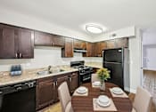 Thumbnail 13 of 20 - Kitchen with black appliances in affordable two bedroom apartment in Marietta Georgia