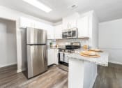 Thumbnail 5 of 20 - a kitchen with stainless steel appliances and a counter top