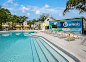 Thumbnail 6 of 34 - A large swimming pool with a Genesis sign in the background.