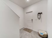 Thumbnail 29 of 30 - Boatman Hammock Townhomes in Lake Worth, FL photo of  the living room and entryway of a home with white walls and a white door