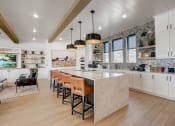 Thumbnail 36 of 56 - a large kitchen with a marble counter top and a dining area