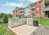 Thumbnail 33 of 48 - A grill area at Hawks Landing in Hickory NC featuring ambient string lighting for a warm outdoor atmosphere