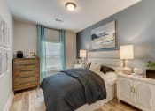 Thumbnail 16 of 56 - a bedroom with a bed and dresser