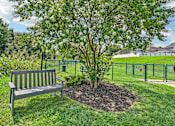 Thumbnail 34 of 48 - A park bench at Hawks Landing in Hickory NC sitting beside a fenced pet park