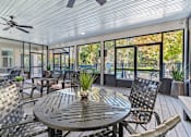 Thumbnail 14 of 16 - Greentree Apartments in Savannah, GA photo of a screened in porch with a table and chairs