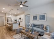 Thumbnail 4 of 34 - an open living room and kitchen with a ceiling fan