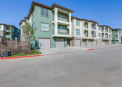 Thumbnail 34 of 34 - an empty parking lot in front of an apartment building