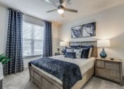 Thumbnail 5 of 34 - the master bedroom has a king sized bed and a ceiling fan