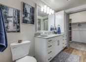 Thumbnail 6 of 34 - a bathroom with a toilet sink and mirror and a shower