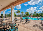 Thumbnail 18 of 32 - Apartments in Hinesville for Rent – Tattersall Village - pool and seating area