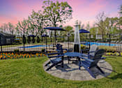 Thumbnail 28 of 48 - A backyard with a table and chairs set up for outdoor dining.