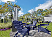 Thumbnail 35 of 48 - A blue chair set sits in a yard.