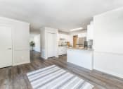 Thumbnail 6 of 20 - a renovated living room and kitchen with a rug