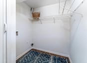 Thumbnail 6 of 17 - a closet in a bedroom with a white wall and a hanging rack