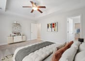 Thumbnail 13 of 26 - Harris Trail Luxury Townhomes for rent Richmond Hill, GA photo of a bedroom with a large bed and a ceiling fan