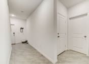 Thumbnail 28 of 30 - Boatman Hammock Townhomes in Lake Worth, FL photo of  a white hallway with two doors and a toilet in the corner