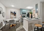 Thumbnail 5 of 34 - A modern kitchen with a dining table and chairs.