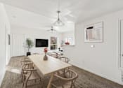 Thumbnail 7 of 19 - Affordable Apartments in Austin, TX for Rent- Huntington Meadows-  A dining room with a wooden table and chairs.