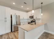 Thumbnail 7 of 56 - a kitchen with white cabinets and stainless steel appliances