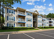 Thumbnail 17 of 18 - Apartment buildings with landscaped grounds at Southwinds Point Apartments in Stockbridge, Georgia.