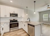 Thumbnail 5 of 56 - a kitchen with white cabinets and stainless steel appliances