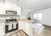 Thumbnail 7 of 20 - a kitchen with white cabinets and stainless steel appliances
